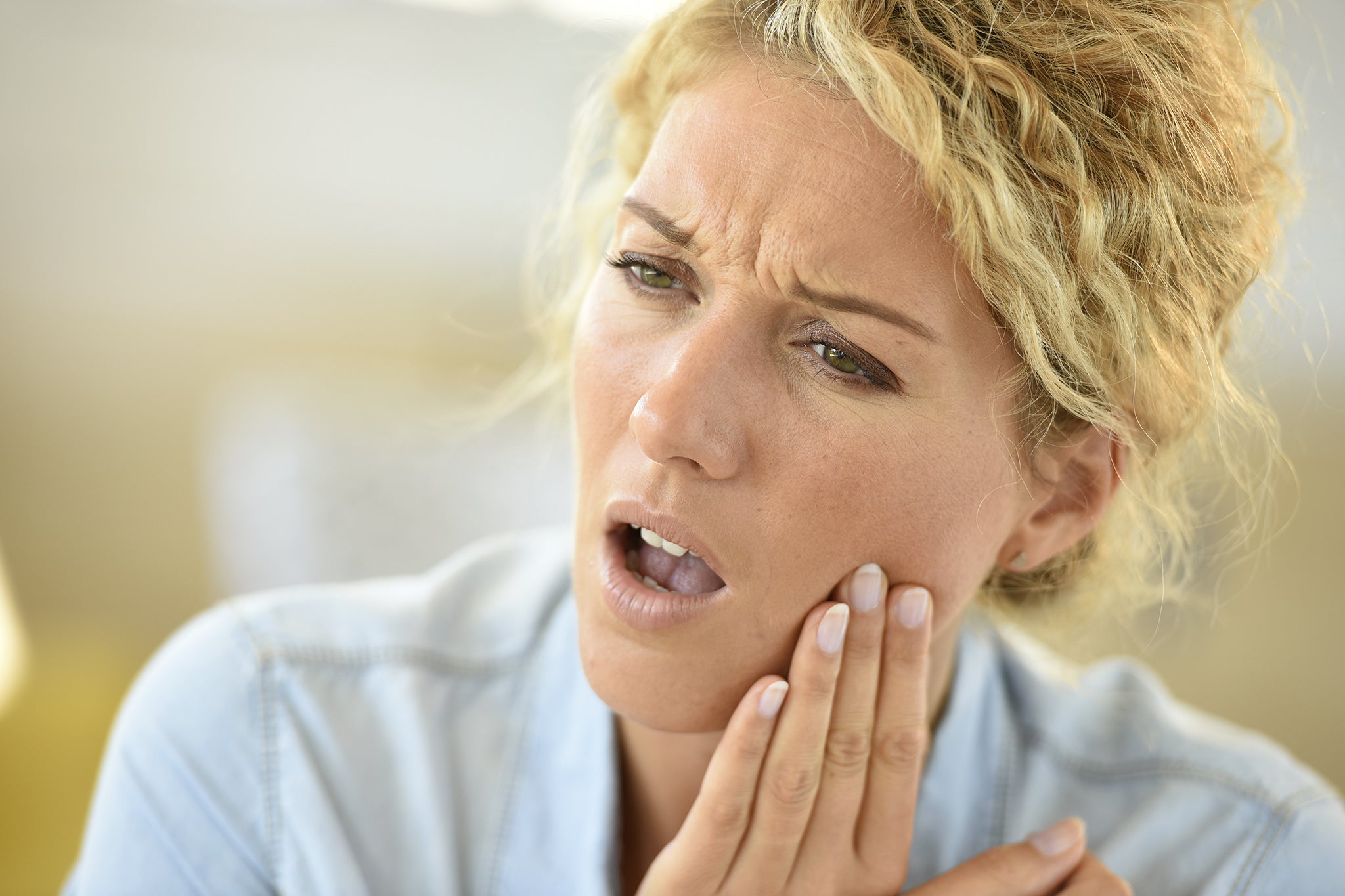 Woman female suffering toothache with blond hair