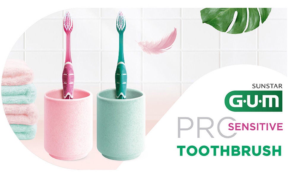 GUM PRO Toothbrushes in their glasses with soem details such as towels, feather and leaf