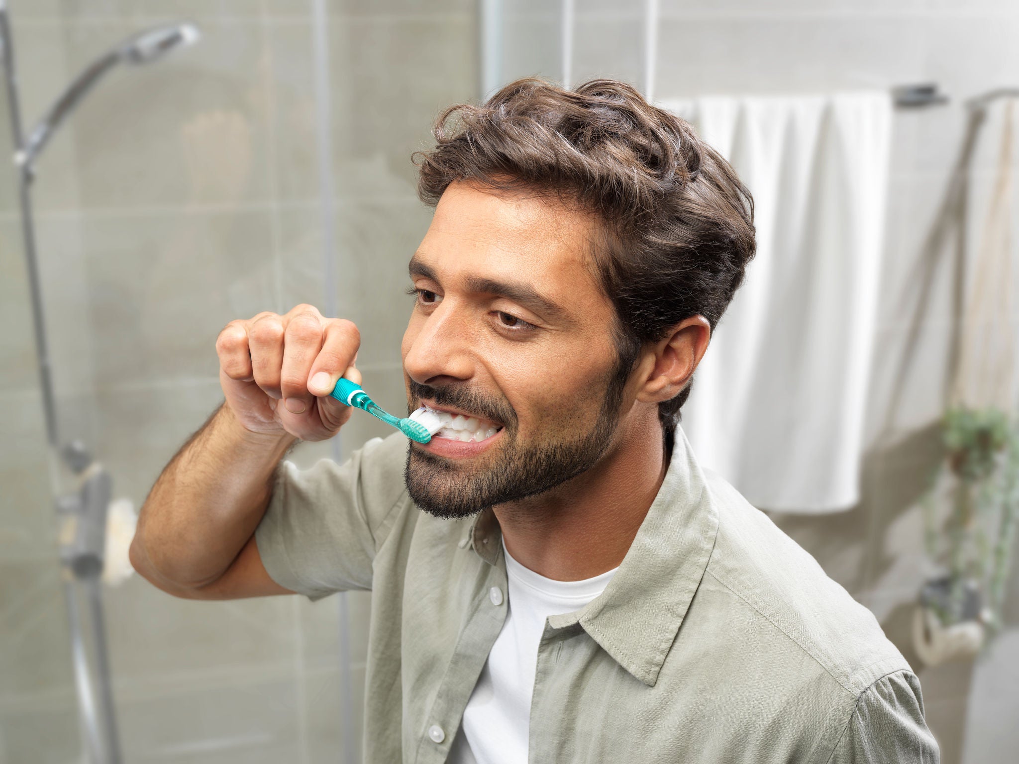 Man start brushing his teeth in the bathroom