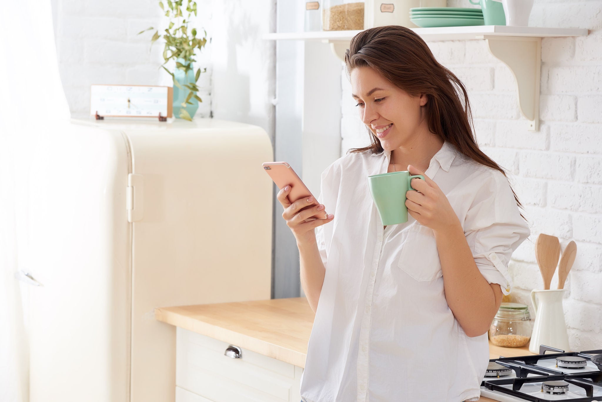 Gorgeous woman drinking water in her kitchen