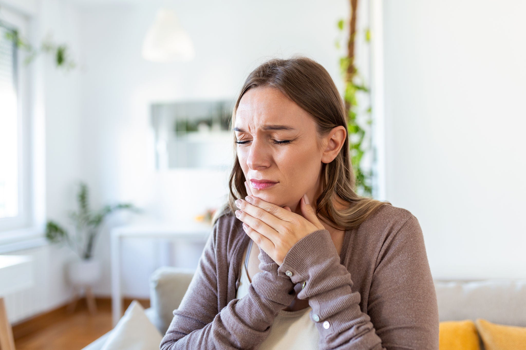 Tooth Pain And Dentistry. Young Woman Suffering From Terrible Strong Teeth Pain, Touching Cheek With Hand. Female Feeling Painful Toothache. Dental Care And Health Concept.