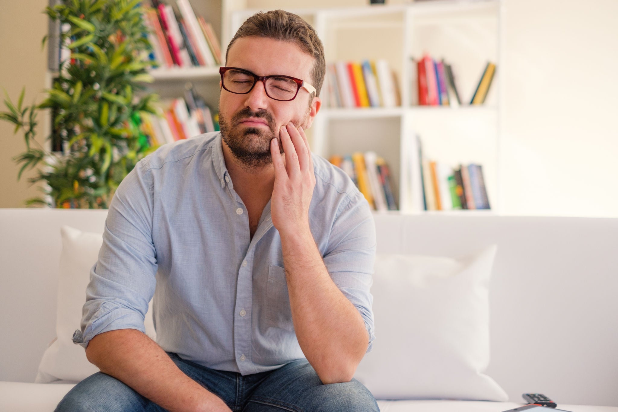 Man portrait feeling tooth ache at home